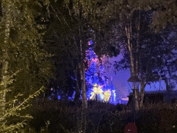 Sleeping Beauty`s Castle at Fantasyland at Disneyland Park, viewed from the Gardens of Wonder attraction, during the Disney Illuminations show, by night