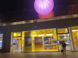 Front of the LEGO Store at the Disney Village street, by night