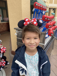 Max with Minnie Mouse ears at a shop at the entrance to Walt Disney Studios Park