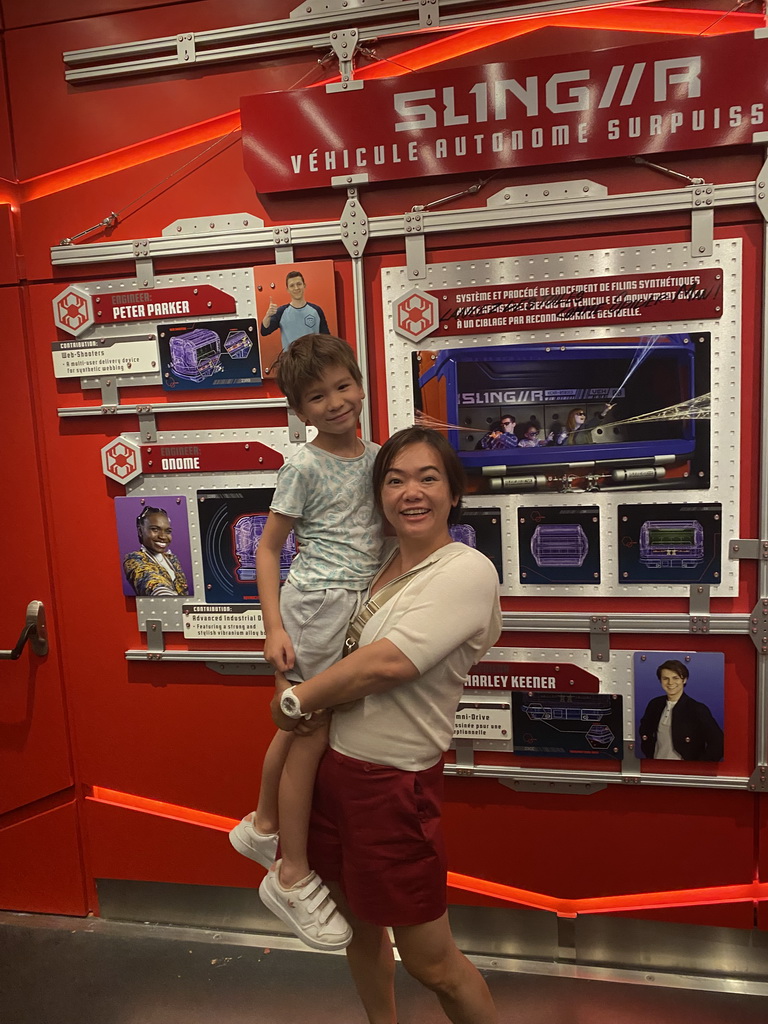 Miaomiao and Max with information on the Slinger vehicle at the queue for the Spider-Man W.E.B. Adventure attraction at the Marvel Avengers Campus at Walt Disney Studios Park