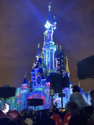 Front of Sleeping Beauty`s Castle at Fantasyland at Disneyland Park, with illuminations during the Disney D-Light drone show, viewed from Central Plaza, by night