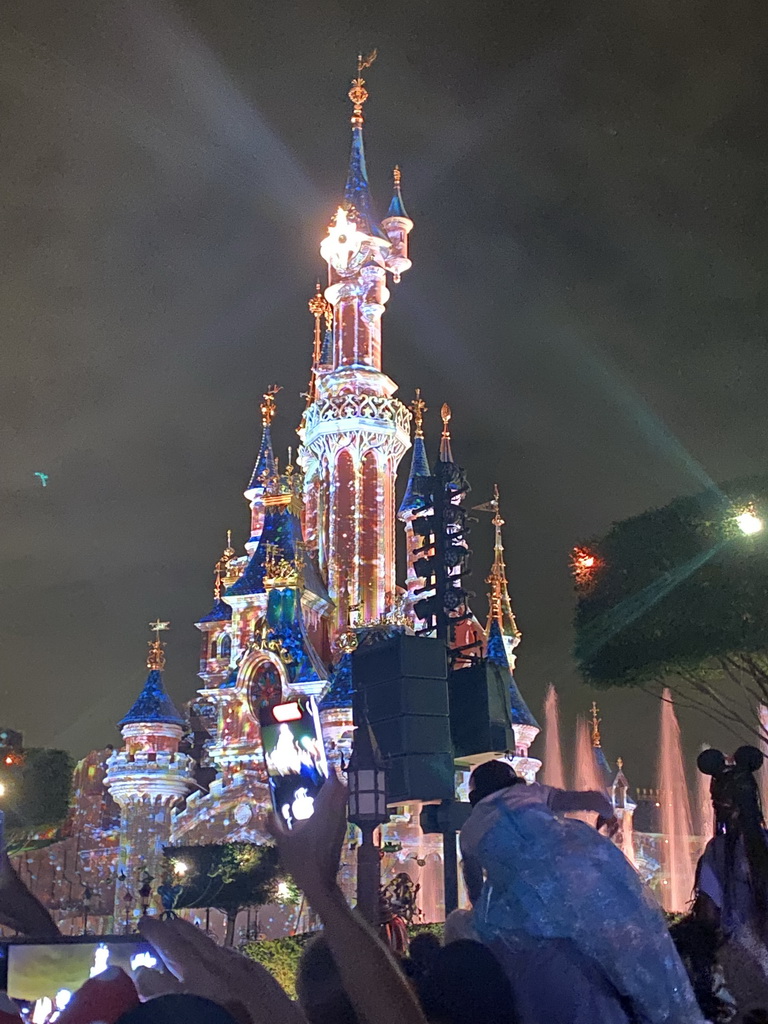 Front of Sleeping Beauty`s Castle at Fantasyland at Disneyland Park, with illuminations during the Disney D-Light drone show, viewed from Central Plaza, by night