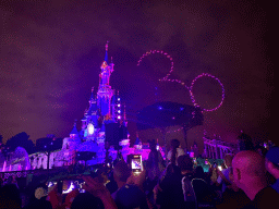 Front of Sleeping Beauty`s Castle at Fantasyland at Disneyland Park, with illuminations and drones during the Disney D-Light drone show, viewed from Central Plaza, by night