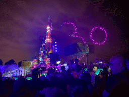 Front of Sleeping Beauty`s Castle at Fantasyland at Disneyland Park, with illuminations and drones during the Disney D-Light drone show, viewed from Central Plaza, by night