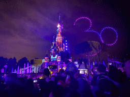 Front of Sleeping Beauty`s Castle at Fantasyland at Disneyland Park, with illuminations and drones during the Disney D-Light drone show, viewed from Central Plaza, by night