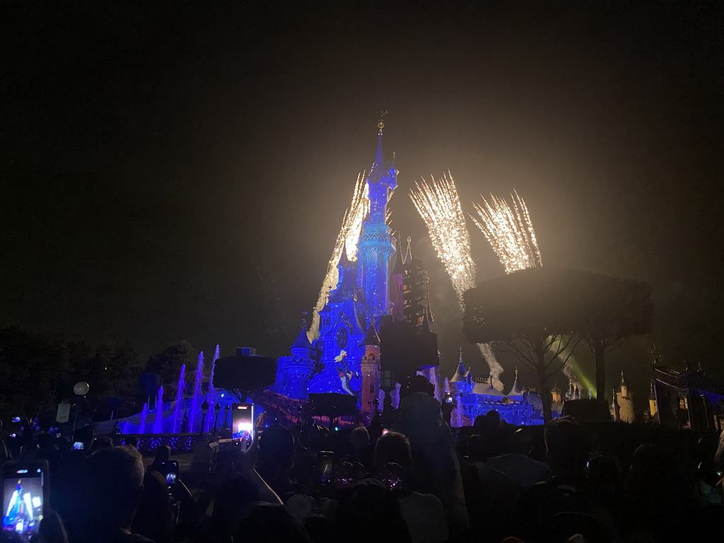 Front of Sleeping Beauty`s Castle at Fantasyland at Disneyland Park, with illuminations, fireworks and fountains during the Disney Illuminations show, viewed from Central Plaza, by night