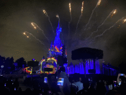 Front of Sleeping Beauty`s Castle at Fantasyland at Disneyland Park, with illuminations, fireworks and fountains during the Disney Illuminations show, viewed from Central Plaza, by night