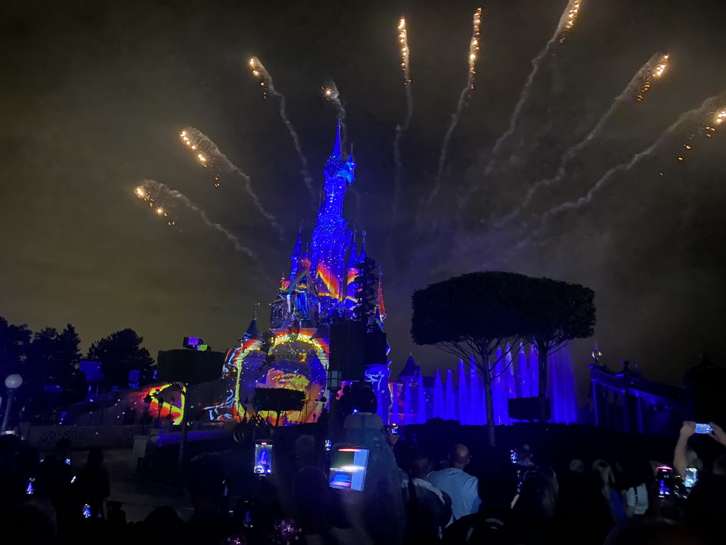 Front of Sleeping Beauty`s Castle at Fantasyland at Disneyland Park, with illuminations, fireworks and fountains during the Disney Illuminations show, viewed from Central Plaza, by night