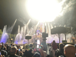 Front of Sleeping Beauty`s Castle at Fantasyland at Disneyland Park, with illuminations, fireworks and fountains during the Disney Illuminations show, viewed from Central Plaza, by night