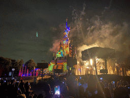 Front of Sleeping Beauty`s Castle at Fantasyland at Disneyland Park, with illuminations, fireworks and fountains during the Disney Illuminations show, viewed from Central Plaza, by night