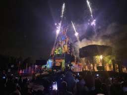 Front of Sleeping Beauty`s Castle at Fantasyland at Disneyland Park, with illuminations, fireworks and fountains during the Disney Illuminations show, viewed from Central Plaza, by night