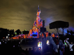 Front of Sleeping Beauty`s Castle at Fantasyland at Disneyland Park, with illuminations during the Disney Illuminations show, viewed from Central Plaza, by night