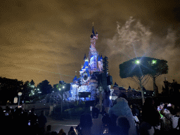 Front of Sleeping Beauty`s Castle at Fantasyland at Disneyland Park, with illuminations during the Disney Illuminations show, viewed from Central Plaza, by night