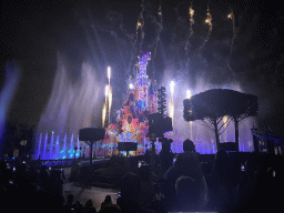 Front of Sleeping Beauty`s Castle at Fantasyland at Disneyland Park, with illuminations, fireworks and fountains during the Disney Illuminations show, viewed from Central Plaza, by night