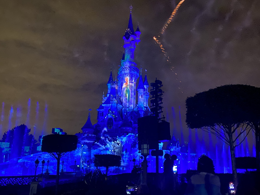 Front of Sleeping Beauty`s Castle at Fantasyland at Disneyland Park, with illuminations, fireworks and fountains during the Disney Illuminations show, viewed from Central Plaza, by night