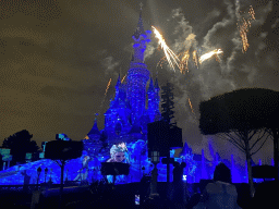 Front of Sleeping Beauty`s Castle at Fantasyland at Disneyland Park, with illuminations, fireworks and fountains during the Disney Illuminations show, viewed from Central Plaza, by night