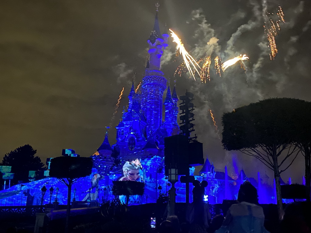 Front of Sleeping Beauty`s Castle at Fantasyland at Disneyland Park, with illuminations, fireworks and fountains during the Disney Illuminations show, viewed from Central Plaza, by night