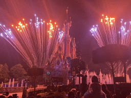 Front of Sleeping Beauty`s Castle at Fantasyland at Disneyland Park, with illuminations, fireworks and fountains during the Disney Illuminations show, viewed from Central Plaza, by night