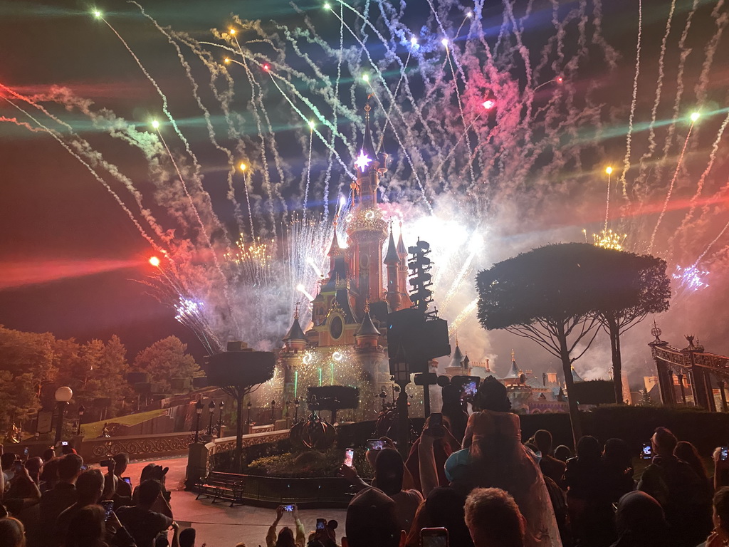 Front of Sleeping Beauty`s Castle at Fantasyland at Disneyland Park, with illuminations and fireworks during the Disney Illuminations show, viewed from Central Plaza, by night