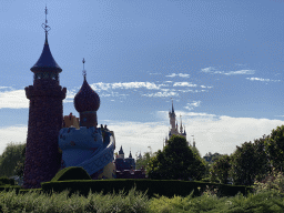 The Queen of Hearts` Castle at the Alice`s Curious Labyrinth attraction and Sleeping Beauty`s Castle at Fantasyland at Disneyland Park, viewed from the train at the Disneyland Railroad attraction