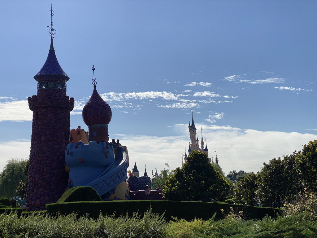 The Queen of Hearts` Castle at the Alice`s Curious Labyrinth attraction and Sleeping Beauty`s Castle at Fantasyland at Disneyland Park, viewed from the train at the Disneyland Railroad attraction