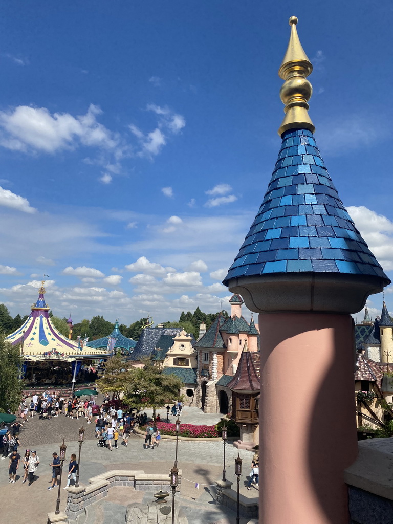 The Le Carrousel de Lancelot and Mad Hatter`s Tea Cups attractions and the Auberge de Cendrillon restaurant at Fantasyland at Disneyland Park, viewed from the balcony at the back side of Sleeping Beauty`s Castle