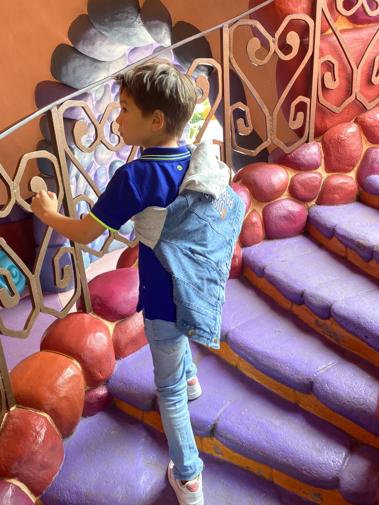 Max at the staircase of the Queen of Hearts` Castle at the Alice`s Curious Labyrinth attraction at Fantasyland at Disneyland Park