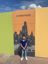 Max with a poster of the Big Thunder Mountain attraction at the Esplanade François Truffaut street