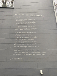 Poem `Tuin Dordrechts Museum` by Jan Eijkelboom on a wall at the garden of the Dordrechts Museum
