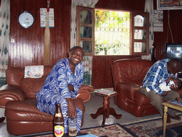 Chicken farmer and other people in the living room of the chicken farmer`s house