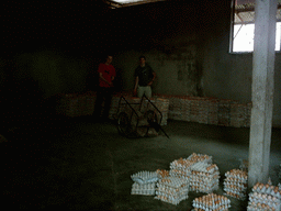 Tim and his friend with eggs at the chicken farm