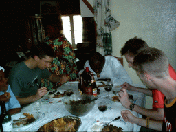 Tim and his friends eating at the chicken farmer`s house