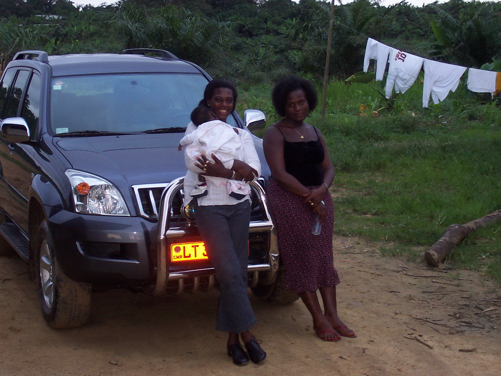 Our friends in front of the car at the chicken farm