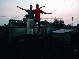 Tim and his friend on top of a pile of stones at a square