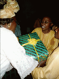People exchanging gifts at a party at the Bonabéri port