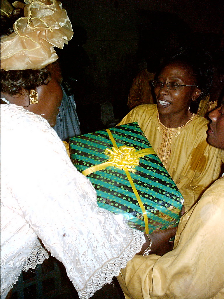 People exchanging gifts at a party at the Bonabéri port