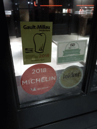 Michelin star and other recommendations at the front door of the La Provence restaurant at the Hoofdstraat street, by night