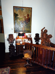 Cabinet, statue and painting in the area at the upper end of the main staircase of Castle Sterkenburg