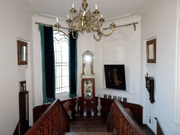Window, paintings, statues and clocks above the main staircase of Castle Sterkenburg