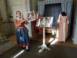 Tour guide, costumes, bed and photographs of paintings at a room at the east side of the Drottningholm Palace Theatre