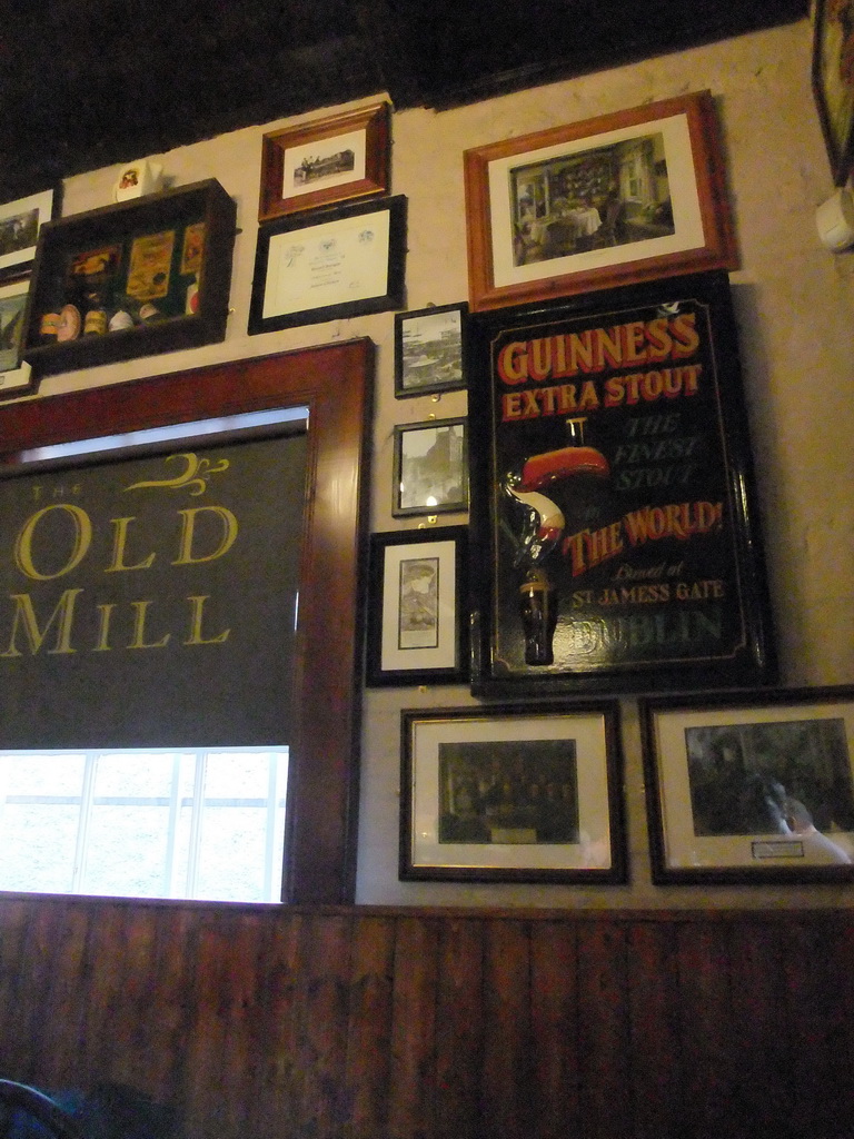 Paintings and advertisements on the wall of the Old Mill Restaraunt in the Temple Bar street