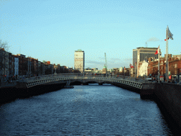 View from the Millennium Bridge over the Ha`penny Bridge over the Liffey river, the Liberty Hall and the Custom House
