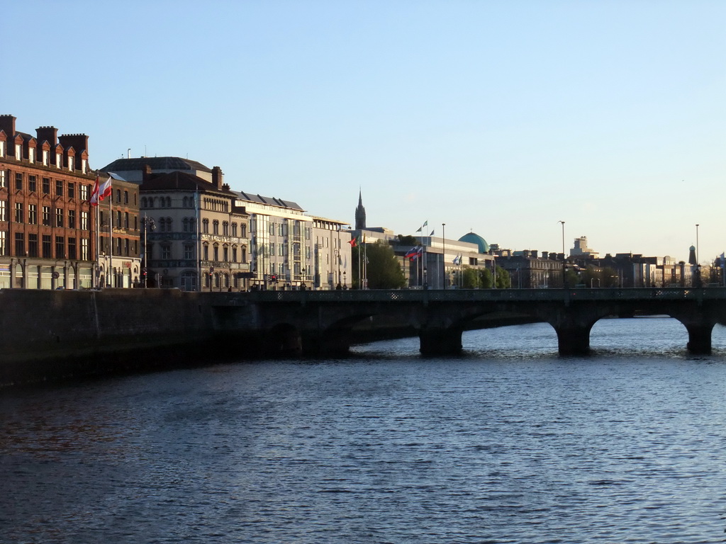 View from the Millennium Bridge over the Capel Street Bridge over the Liffey river, Wellington Quay and the tower of John`s Lane Church