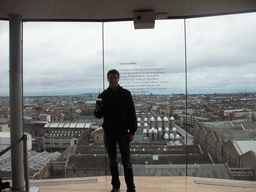 Tim with a pint of Guinness beer at the top floor of the Guinness Storehouse, with a view on the Trinity College Dublin and the city center