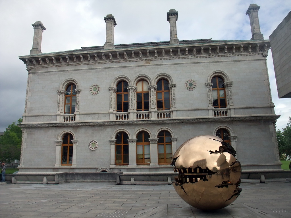 `Sfera con sfera` sculpture by Arnaldo Pomodoro and the side of the Museum Building at Trinity College Dublin