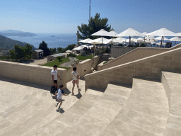 Miaomiao and Max walking to the terrace of the Restaurant Panorama at Mount Srd, with a view on the hills to the east