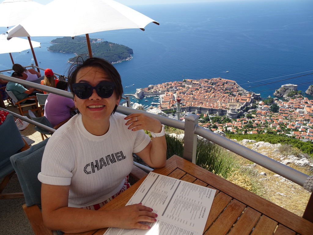 Miaomiao at the terrace of the Restaurant Panorama at Mount Srd, with a view on the Old Town, Fort Lovrijenac and the Lokrum island