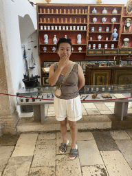 Miaomiao with vases and cups at the museum at the Franciscan Monastery