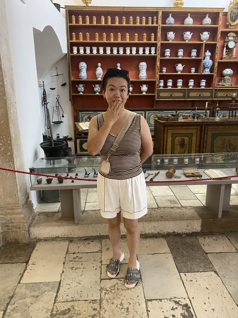 Miaomiao with vases and cups at the museum at the Franciscan Monastery