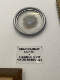 Hole from a missile shot at the museum at the Franciscan Monastery, with explanation